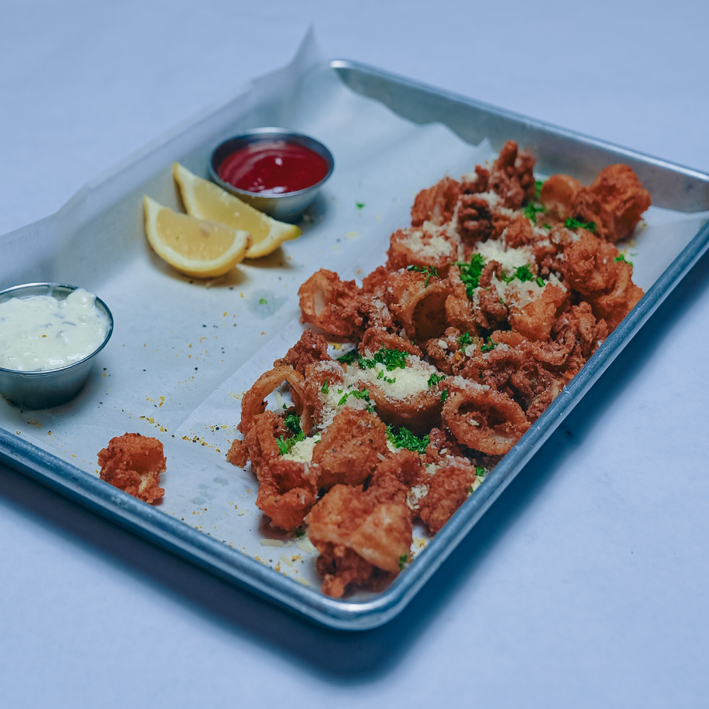 Calamari served with cocktail, tartar and lemons